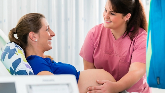 pregnant woman having checkup with her Alberta midwife